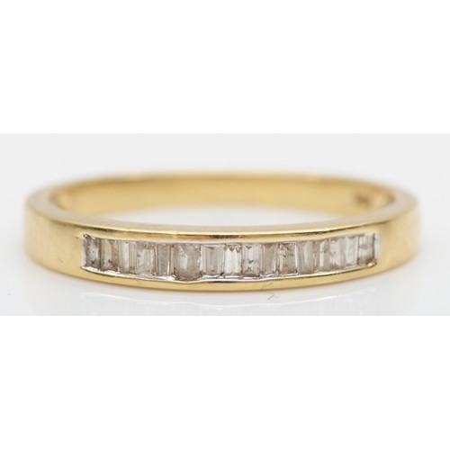 186 - A 14K gold and baguette diamond channel set half eternity ring, N 1/2, 1.8gm,