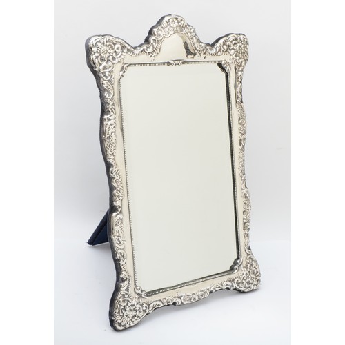 4 - A silver framed easel mirror, Sheffield 1991, with embossed decoration, 38 x 24cm