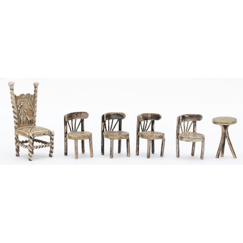 26 - A late 19th century German silver chair, Hanau marks, with embossed decoration and a set of four cha... 