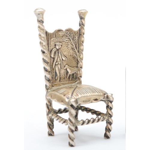 26 - A late 19th century German silver chair, Hanau marks, with embossed decoration and a set of four cha... 