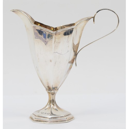 58 - A Victorian silver octagonal panelled cream jug, Birmingham 1899, raised on a pedestal foot, 13cm, 8... 