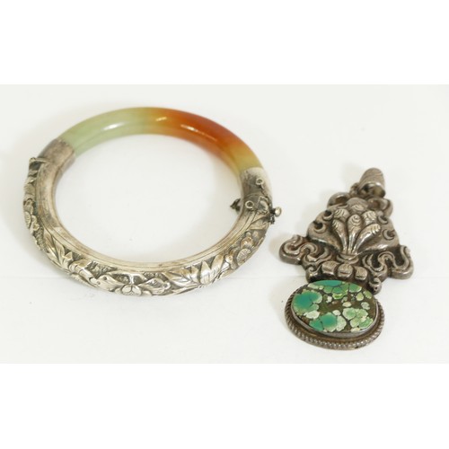185 - A Chinese silver and mottled jadeite hinged bangle, 56mm internal diameter and a Chinese silver and ...