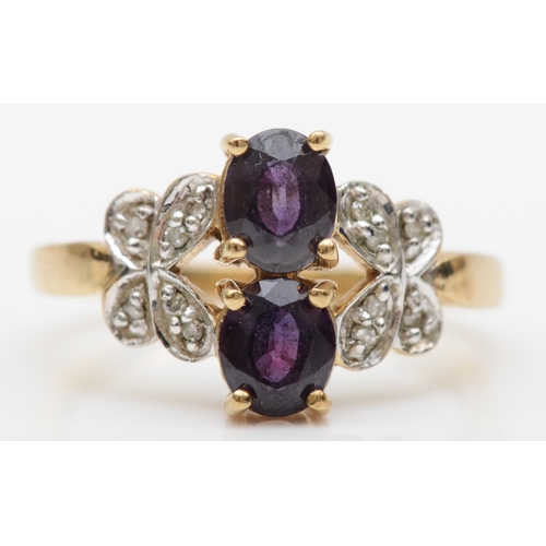 385 - A 9ct gold synthetic colour change alexandrite dress ring, set with diamond butterfly shoulders, N-O... 