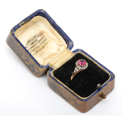 390 - An unmarked 18ct gold ruby and old cut diamond cluster ring, claw set circular 6mm stone, with diamo... 