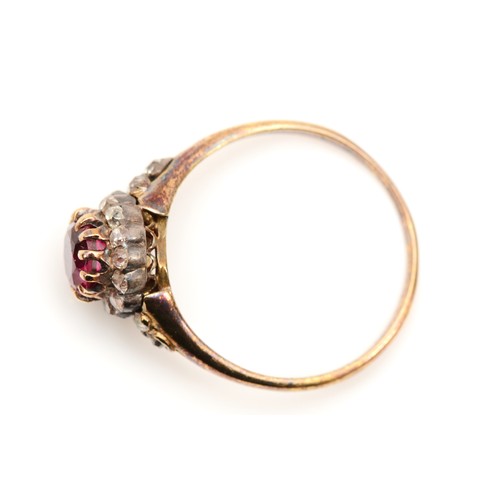 390 - An unmarked 18ct gold ruby and old cut diamond cluster ring, claw set circular 6mm stone, with diamo... 