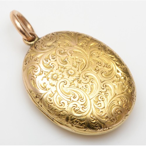 435 - A Victorian unmarked gold oval locket, tests as 15cts, with all over floral engraved decoration, 23 ... 