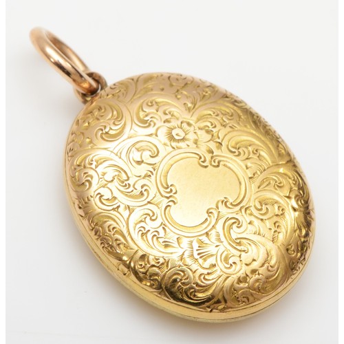 435 - A Victorian unmarked gold oval locket, tests as 15cts, with all over floral engraved decoration, 23 ... 