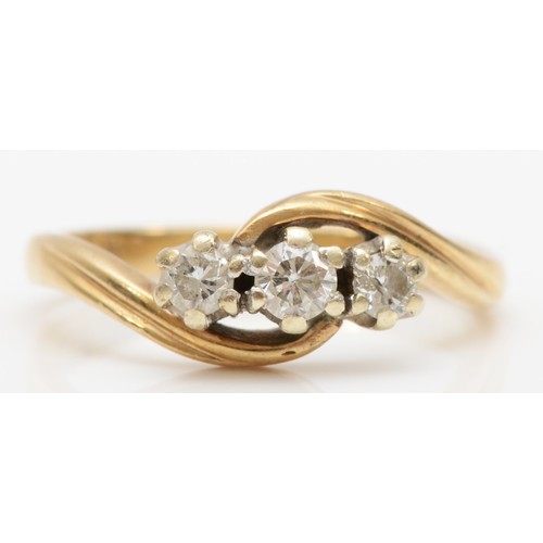 452 - A 9ct gold and brilliant cut diamond three stone ring, stated weight 0.25cts, K 1/2, 2.5gm