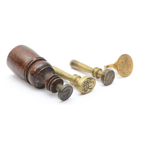 246 - Three brass hand seals and a mahogany hand seal