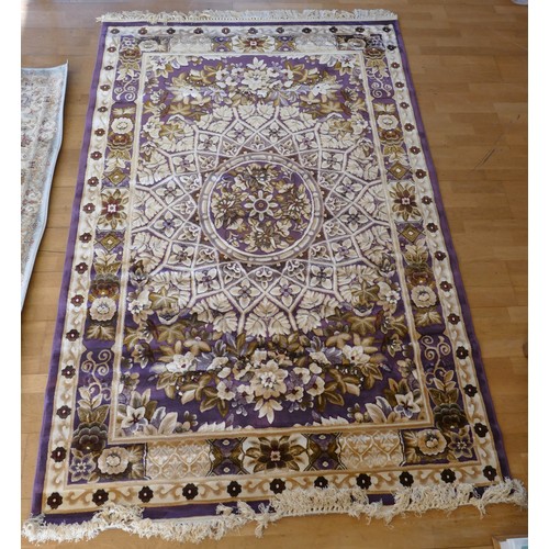 A purple and cream background wool/silk mix rug with floral decoration ...