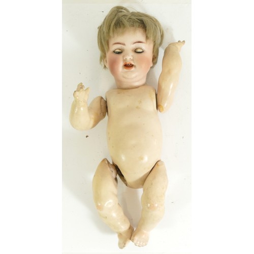 210 - A 20th century porcelain headed and papier-mâché articulated doll, impressed marks to back of the he... 