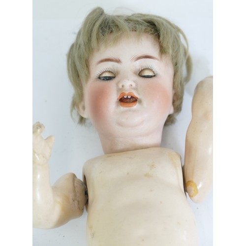 210 - A 20th century porcelain headed and papier-mâché articulated doll, impressed marks to back of the he... 