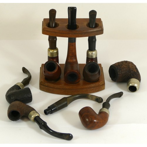 345 - Seven Irish Peterson pipes and a three pipe stand