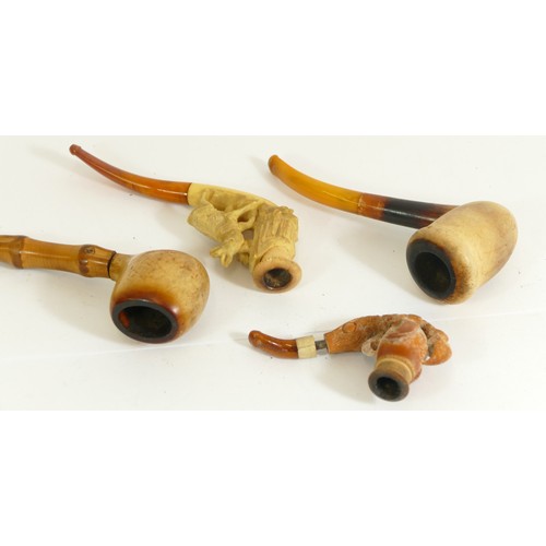 356 - A carved Meerschaum pipe of a mountain goat, another of a claw and two plain examples