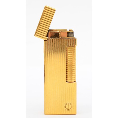 369 - Dunhill, a gold plated Rollagas lighter, with ribbed body, original booklet, tag, spare flints, case... 