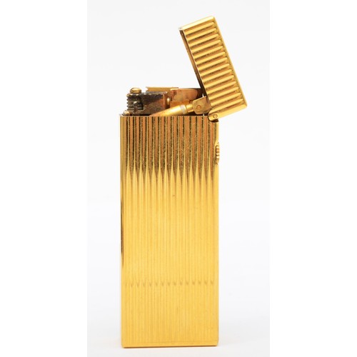 369 - Dunhill, a gold plated Rollagas lighter, with ribbed body, original booklet, tag, spare flints, case... 