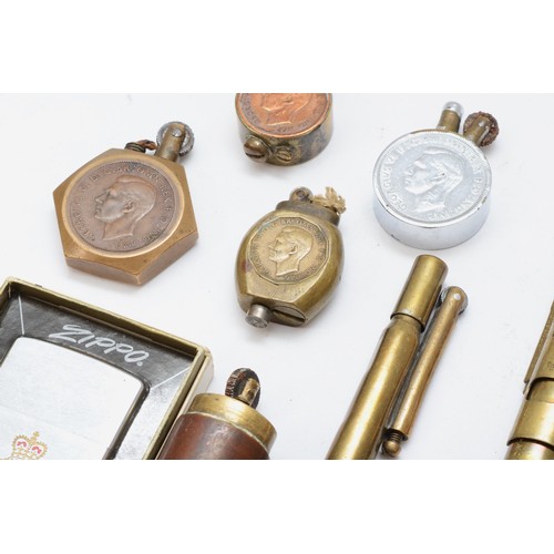 381 - A 1939 one penny Trench Art petrol lighter, three other similar, a Zippo 43rd Fighter Squadron RAF l... 