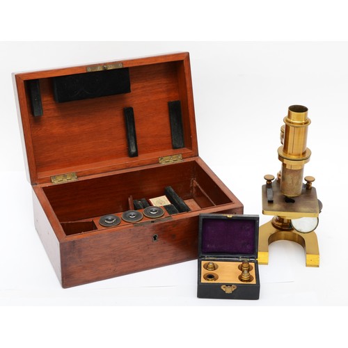 422 - A 19th century brass unsigned students microscope, 22cm, with three eye pieces and four lower lens, ... 