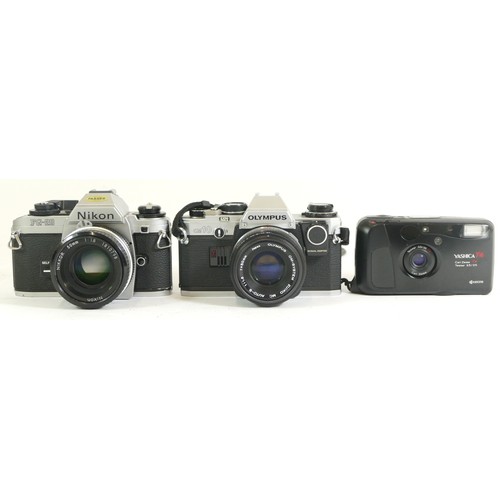 427 - Three cameras comprising of a Nikon FG-20 with a 1:1.8 50mm lens, an Olympus OM10 with an Olympus OM... 