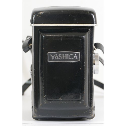 429 - A Yashica-24 camera together with a Yashinon 1:2.8 80mm lens, with carrying case.