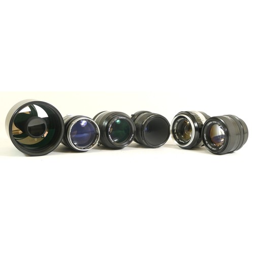 434 - Six assorted camera lenses comprising of a Canon FD 50mm 1:1.4, a Nikon Nikkor 1:2.5 105mm lens, a C... 