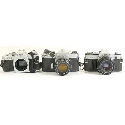 440 - Three assorted cameras comprising boxed Canon AV-1 camera body, Pentax Spotmatic camera with a Asahi... 