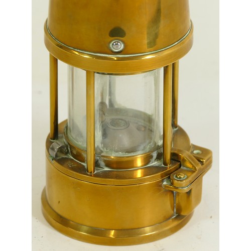 472 - A brass miners lamp, by Eccles having attached makers plaque, 24cm tall.