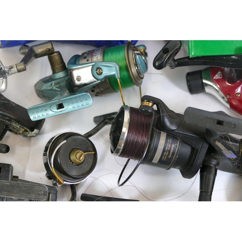 494 - A collection of mid 20th century and later fishing reels, makers to include; Mitchell, Shakespeare, ... 