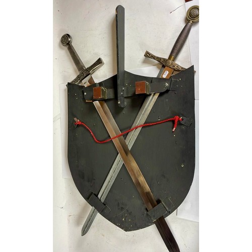 552 - A decorative wall hanging sword and shield, 88 x 62cm.

This bladed product is not for sale to peopl... 