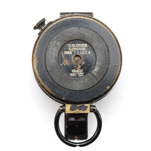 554 - A WWII British military compass, by T.G.Co Ltd, London, numbered 261024, broad arrow, 1943, MkIII.