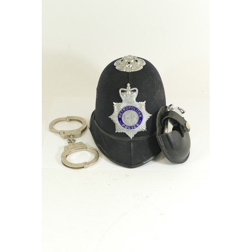 557 - Metropolitan Police Policeman's helmet, size 6 2/8, and two pairs of Hiatts handcuffs