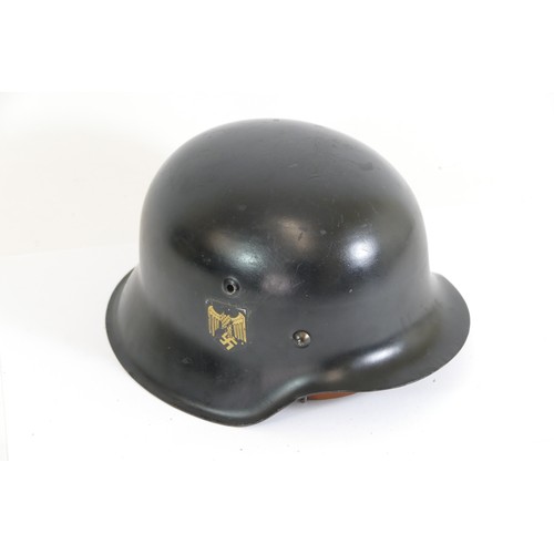 560 - A German WWII M42 helmet, double decal, stamped K064 and 4138, leather liner stamped crowned CF, CFo... 