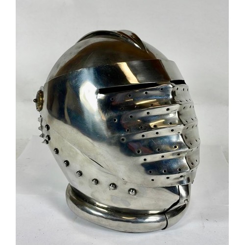 562 - A decorative maximus helmet with bellows visor, 26cm.