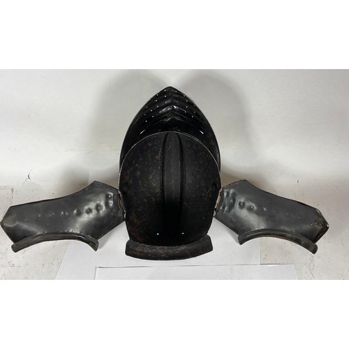 562 - A decorative maximus helmet with bellows visor, 26cm.