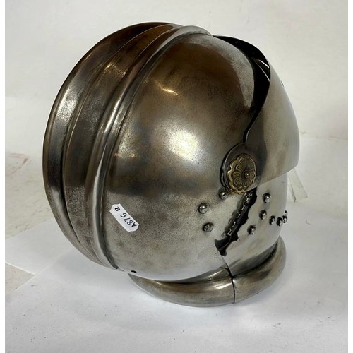 562 - A decorative maximus helmet with bellows visor, 26cm.