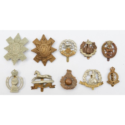 582 - Ten military cap badges, including the Black Watch and Norfolk