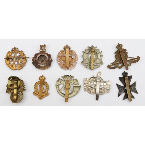 585 - Ten military cap badges, including the Tank Corp and Royal Marines