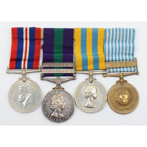 597 - WWII/ERII mounted group of four, Defense, G.S.M. with Malaya and Cyprus bars, Korea, United Nations ... 