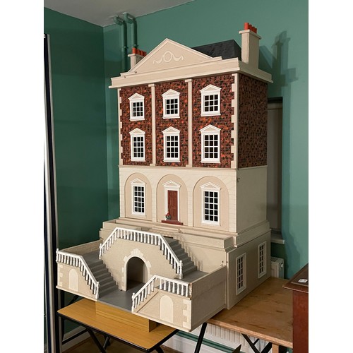 209 - A large impressive Georgian style four storey dolls house, the hinged double panel frontage with bal... 