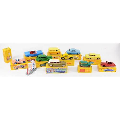 184 - A collection of eleven reproduction Dinky diecast model vehicles, boxed, together with an Atlas tin ... 