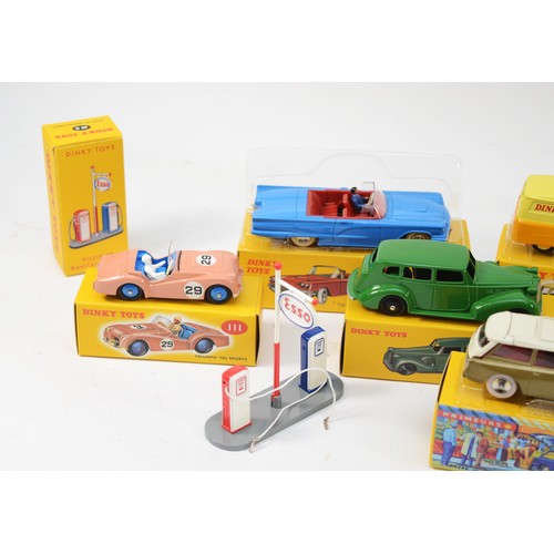 184 - A collection of eleven reproduction Dinky diecast model vehicles, boxed, together with an Atlas tin ... 