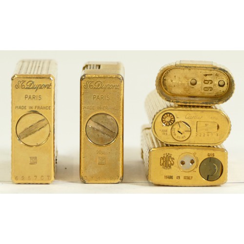 367 - Cartier, a gold plated gas lighter, cover detached, serial 22247 X, two S.T Dupont gold plated petro... 