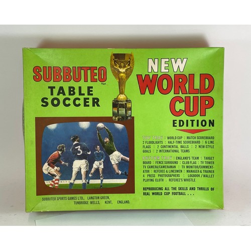 214 - Subbuteo; a boxed World Cup edition football games, complete with accessories.