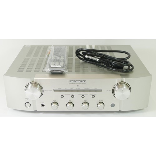 244A - Marantz, a silver PM7004 amplifier, with power lead and remote.