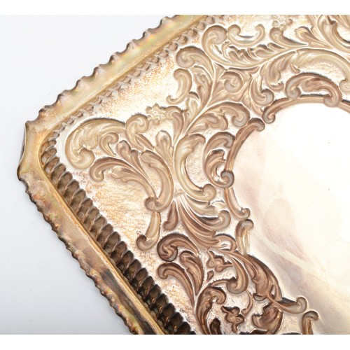 48 - A Victorian silver dressing table tray, Birmingham 1899, with embossed decoration 27 x 19cm, 298gm