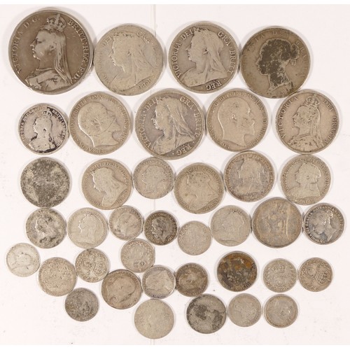 69 - A group of British silver coinage to include a 1889 crown, 1896 half crown and other coinage.