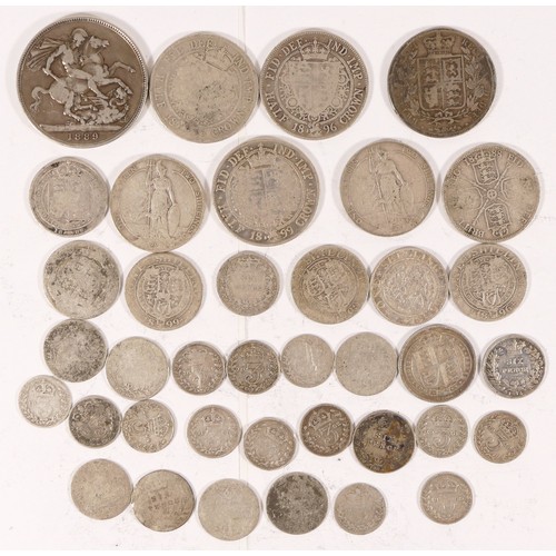 69 - A group of British silver coinage to include a 1889 crown, 1896 half crown and other coinage.