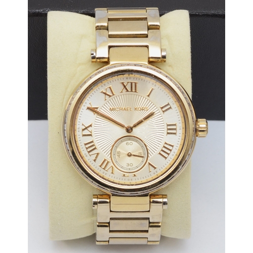 97 - Michael Kors, a stainless steel gold plated quartz ladies wristwatch, SKYLAR MK- 5867, together with... 