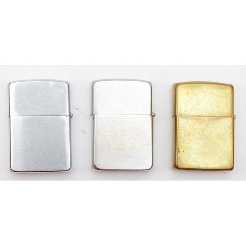 129 - Zippo, three petrol lighters, ERII Maze Compound, Brass, dated 1989 and chrome.