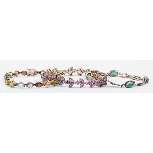 156 - A silver amethyst tennis bracelet, 19.5cm, together with a silver multi gem set example and another,... 